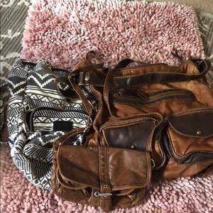 3 purses. Black and white is a mini vs backpack.